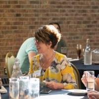 people sitting at a table drinking water